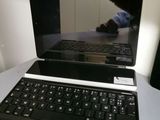 a laptop computer sitting on a table with a cat on the screen