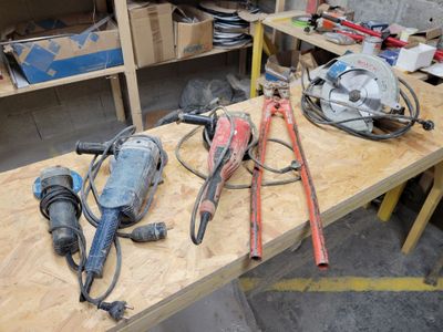 many tools on a workbench in a garage