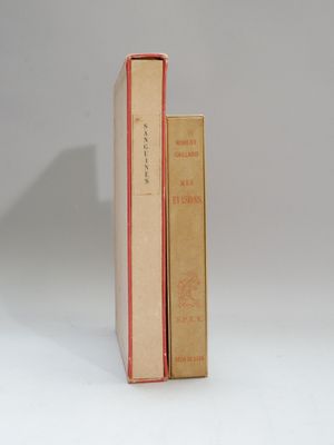 two books are stacked on top of each other on a white surface
