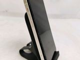 a cell phone that is sitting on top of a stand