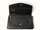 the inside of a black leather wallet with a gold clasp