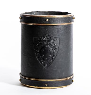 une vieille coupe en cuir noir ornée d'un blason