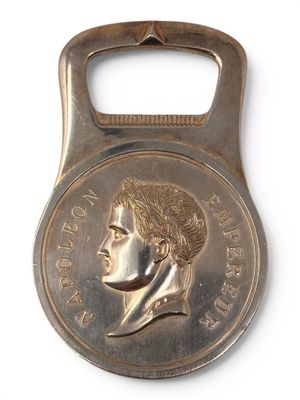 bottle opener shaped like a coin with a portrait of a woman