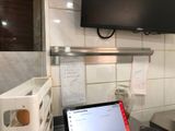 a laptop computer sitting on a counter in a kitchen
