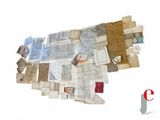 a pile of old maps on a white surface