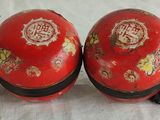 two red vases sitting next to each other on a table