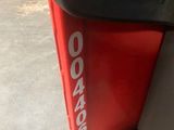 a close up of the side of a red and black bus