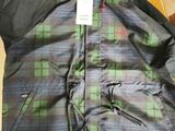 the jacket is green and black with a plaid pattern on it