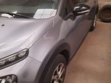 a silver car that is parked in a garage