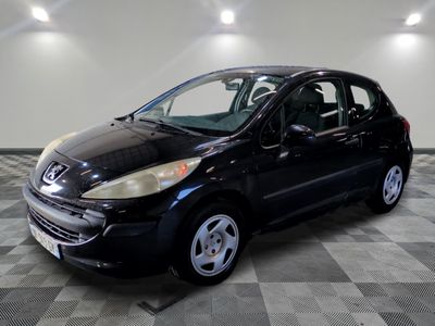 a picture of a small black car in a showroom