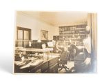 an old photo of a woman working at a desk