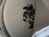 a white plate with a flower on it in a white bag