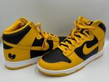 a pair of yellow and black sneakers on a white surface