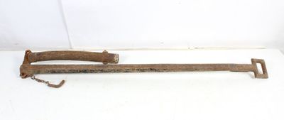 an old rusted metal pipe cutter on a white surface