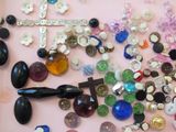 a lot of buttons and a pair of scissors on a pink surface