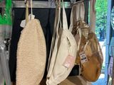 many bags hanging on a rack in a store