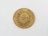 an old gold coin on a white surface with a white background