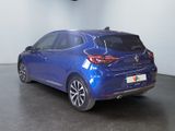 the rear end of a blue car in a showroom