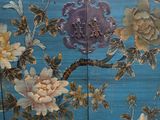 a blue screen with a painting of flowers on it