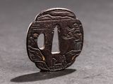 a small metal object with a design on it