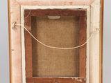an old wooden easel with a picture frame on top of it