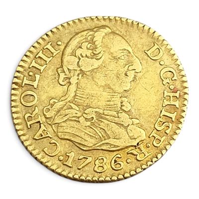 gros plan d'une pièce d'or sur une surface blanche