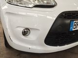 a close up of a white car with a number plate on it