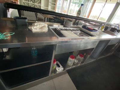 a man standing in a kitchen preparing food on the counter