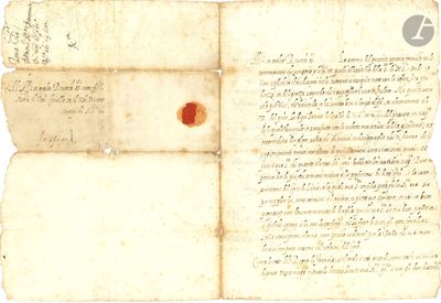 un vieux document marqué d'un point rouge, posé sur une feuille de papier