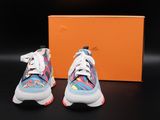 a pair of colorful sneakers with a box in the background