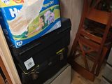 a stack of boxes sitting on top of a refrigerator
