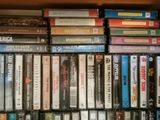 a lot of dvds stacked on a shelf in a room