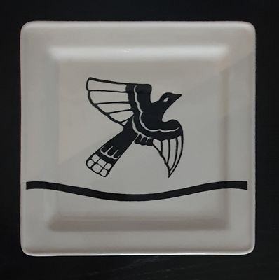 a black and white plate with a bird on it