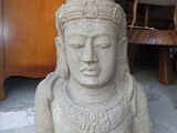 a stone statue of a woman with a hat on