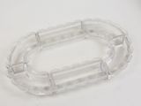 a clear plastic object on a table with a white background