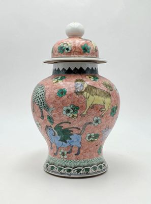 an image of a pink and green vase with a lid on a white background