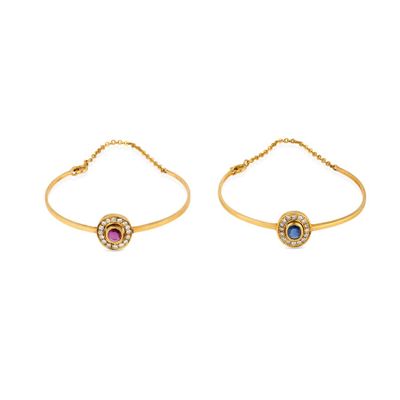 a pair of gold bracelets with blue and pink stones