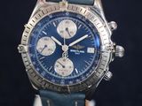 the watch is blue and has a leather strap on it