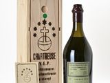 a bottle of wine in front of a wooden box