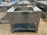 a stainless steel sink in the middle of a room