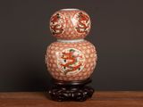 a vase that has a dragon on it on a table