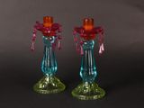 pair of colorful glass candlesticks on a black background