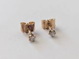 une paire de boucles d'oreilles en or et diamants sur fond blanc