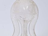 a clear glass bottle with a clear top on a white surface
