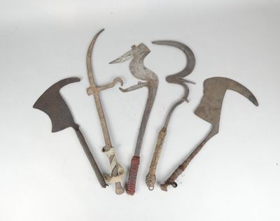 several old tools are displayed on a white surface