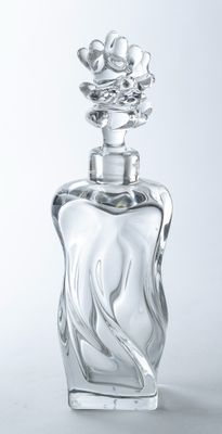 a glass bottle with a flower on top of it