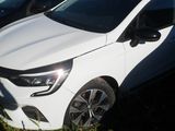 a white car that is parked in the grass