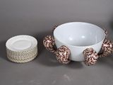 a white bowl with a red and white design on it