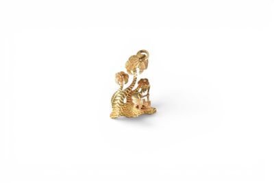 a gold plated figurine of a cat and a dog