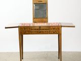 a small wooden table with a mirror on top of it